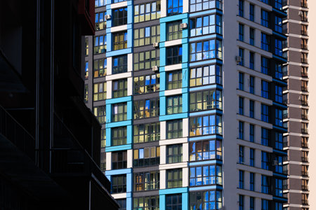 City view on a sunny day. Modern buildings, walls and windows.の写真素材