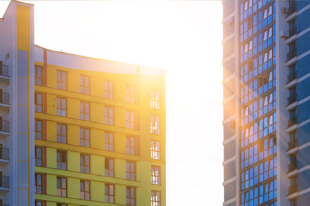 Modern buildings, walls and windows, reflections and sun rays. City view on a sunny day.の写真素材