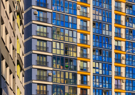 City view on a sunny day. Modern buildings, walls and windows.の写真素材