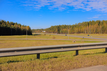 Road shoulder on a sunny autumn day. Views of the landscape from the car window.