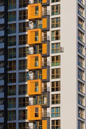 City view on a sunny day. Modern buildings, walls and windows.
