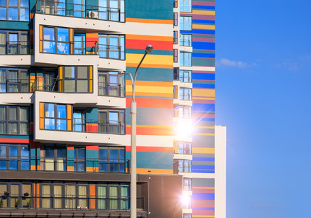 Modern buildings, walls and windows, reflections and sun rays. City view on a sunny day.の写真素材