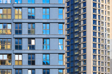 City view on a sunny day. Modern buildings, walls and windows.の写真素材