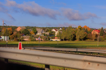 Road shoulder on a sunny autumn day. Views of the landscape from the car window.の写真素材