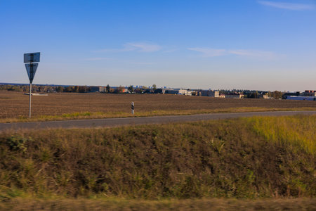 Road shoulder on a sunny autumn day. Views of the landscape from the car window.の写真素材