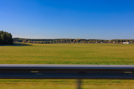 Road shoulder on a sunny autumn day. Views of the landscape from the car window.の写真素材