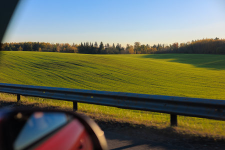 Road shoulder on a sunny autumn day. Views of the landscape from the car window.の写真素材