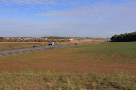 Road shoulder on a sunny autumn day. Views of the landscape from the car window.の写真素材