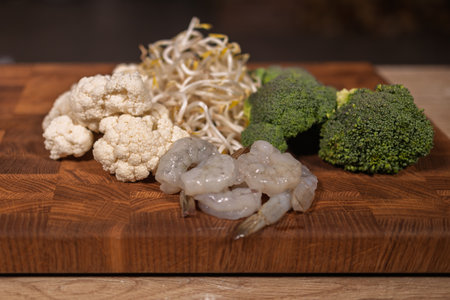 Cooking a dish, vegetables with shrimp and saucesの写真素材
