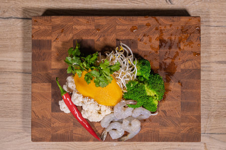 Cooking a dish, vegetables with shrimp and saucesの写真素材