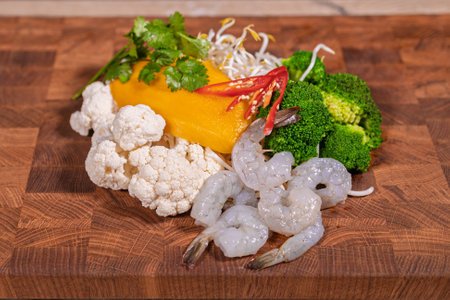 Cooking a dish, vegetables with shrimp and saucesの写真素材