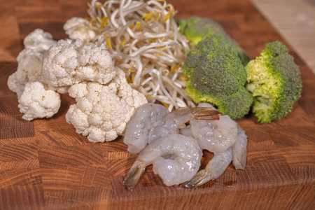 Cooking a dish, vegetables with shrimp and saucesの写真素材