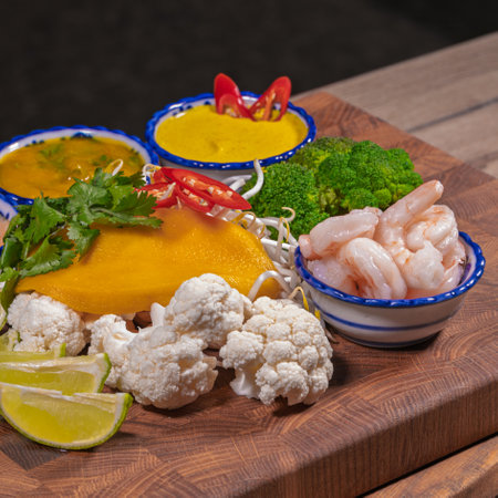 Cooking a dish, vegetables with shrimp and saucesの写真素材