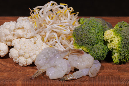 Cooking a dish, vegetables with shrimp and saucesの写真素材