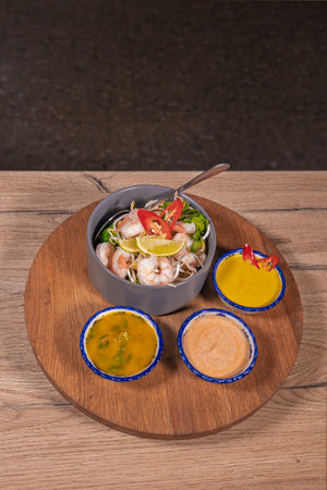 Cooking a dish, vegetables with shrimp and saucesの写真素材