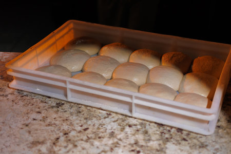 round buns made of white flour dough, baking preparation