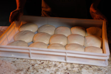 round buns made of white flour dough, baking preparation