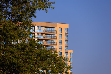Modern buildings, walls and windows, reflections and sun rays. City view on a sunny day.の写真素材