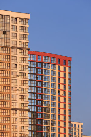 Modern buildings, walls and windows, reflections and sun rays. City view on a sunny day.の写真素材