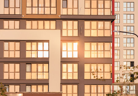 Modern buildings, walls and windows, reflections and sun rays. City view on a sunny day.の写真素材