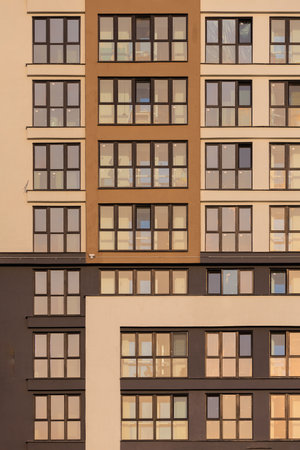 Modern buildings, walls and windows, reflections and sun rays. City view on a sunny day.の写真素材