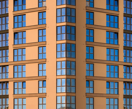 Modern buildings, walls and windows, reflections and sun rays. City view on a sunny day.の写真素材