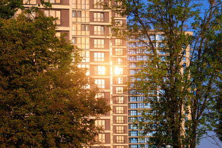 Modern buildings, walls and windows, reflections and sun rays. City view on a sunny day.の写真素材
