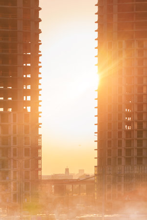 Modern buildings, walls and windows, reflections and sun rays. City view on a sunny day.の写真素材