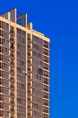 Modern buildings, walls and windows, reflections and sun rays. City view on a sunny day.の写真素材