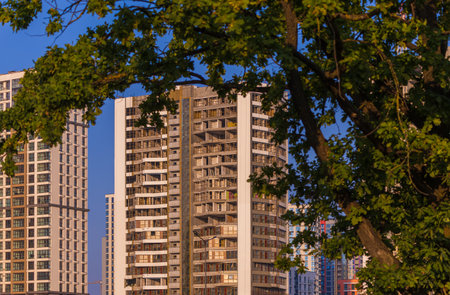 Modern buildings, walls and windows, reflections and sun rays. City view on a sunny day.の写真素材
