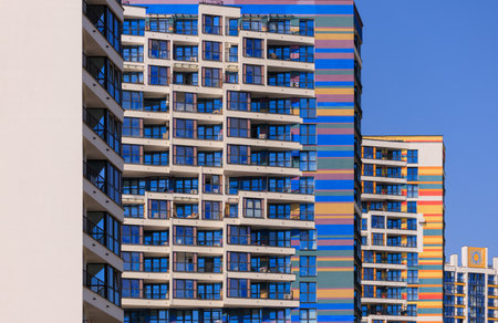 City view on a sunny day. Modern buildings, walls and windows.の写真素材