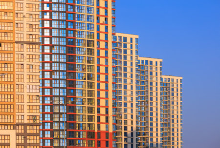 Modern buildings, walls and windows, reflections and sun rays. City view on a sunny day.の写真素材