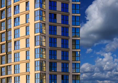 Modern buildings, walls and windows, reflections and sun rays. City view on a sunny day.の写真素材