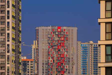 Modern buildings, walls and windows, reflections and sun rays. City view on a sunny day.の写真素材