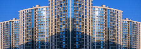 City view on a sunny day. Modern buildings, walls and windows.の写真素材