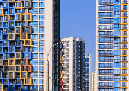 City view on a sunny day. Modern buildings, walls and windows.の写真素材