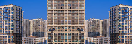 City view on a sunny day. Modern buildings, walls and windows.の写真素材