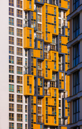 City view on a sunny day. Modern buildings, walls and windows.の写真素材