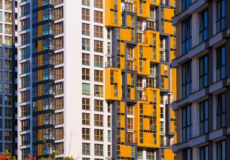 City view on a sunny day. Modern buildings, walls and windows.