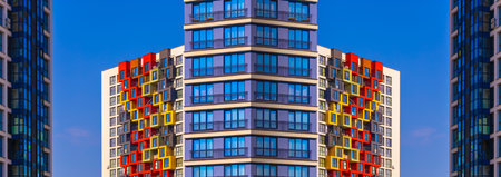 City view on a sunny day. Modern buildings, walls and windows.