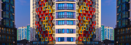 City view on a sunny day. Modern buildings, walls and windows.