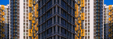 City view on a sunny day. Modern buildings, walls and windows.の写真素材