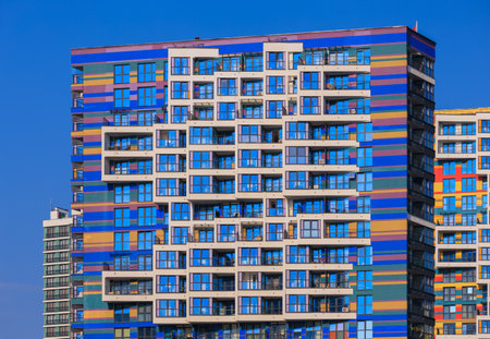 City view on a sunny day. Modern buildings, walls and windows.