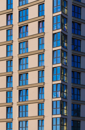 City view on a sunny day. Modern buildings, walls and windows.の写真素材