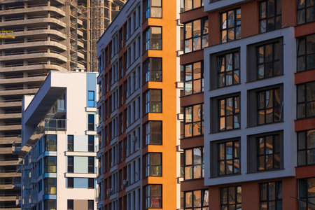 City view on a sunny day. Modern buildings, walls and windows.の写真素材