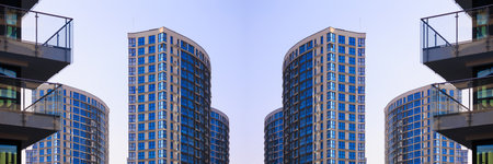 City view on a sunny day. Modern buildings, walls and windows.の写真素材