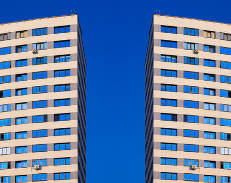 City view on a sunny day. Modern buildings, walls and windows.