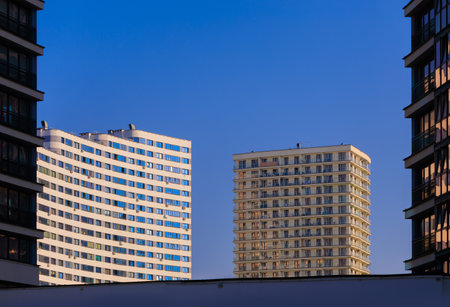 City view on a sunny day. Modern buildings, walls and windows.の写真素材