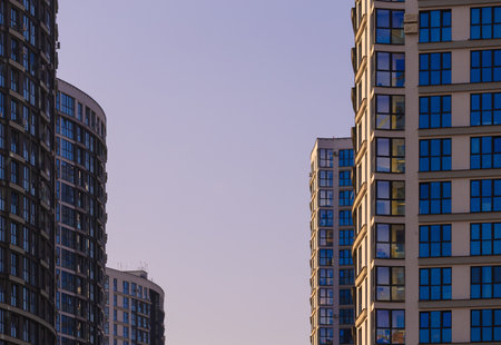 City view on a sunny day. Modern buildings, walls and windows.の写真素材