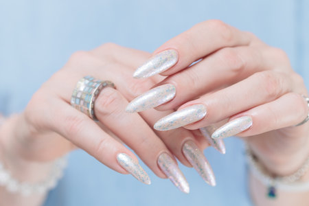 beautiful female hands with long nails light white manicureの写真素材